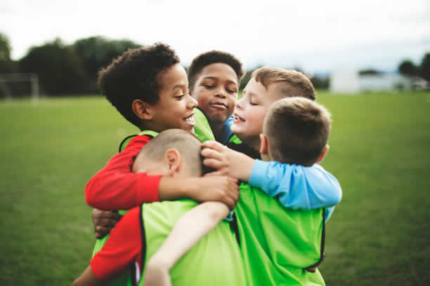 An image of a group of young players hugging
